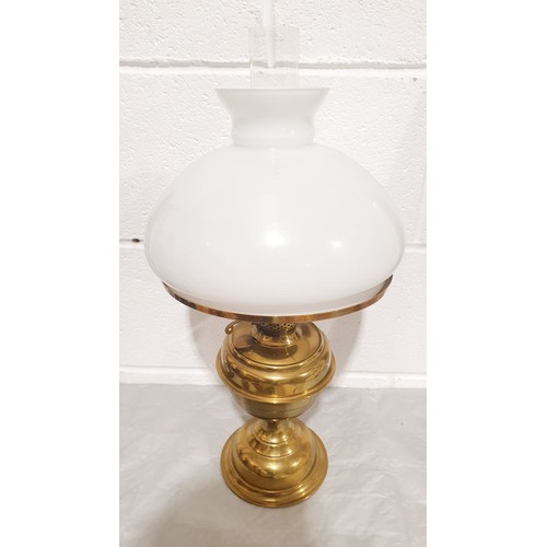 369 - An antique brass oil lamp, height 20