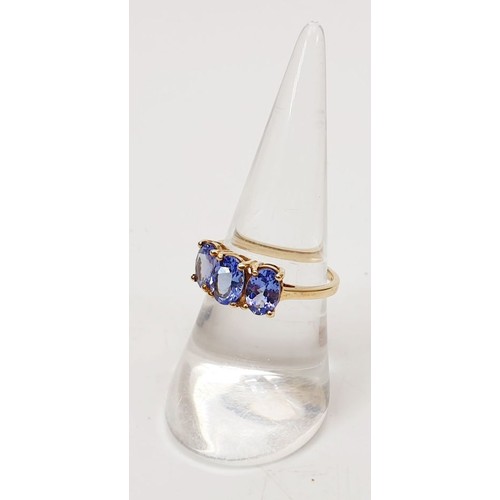 27 - A hallmarked 9ct gold ring set with tanzanite, size O, gross weight 2.1g. UK shipping £14.