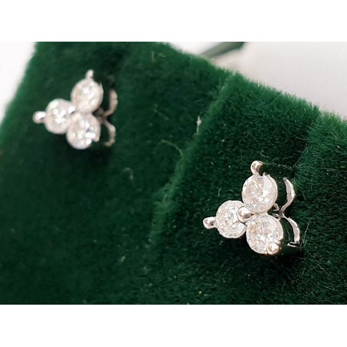 24 - A pair of hallmarked 14ct white gold diamond earrings. UK shipping £14.