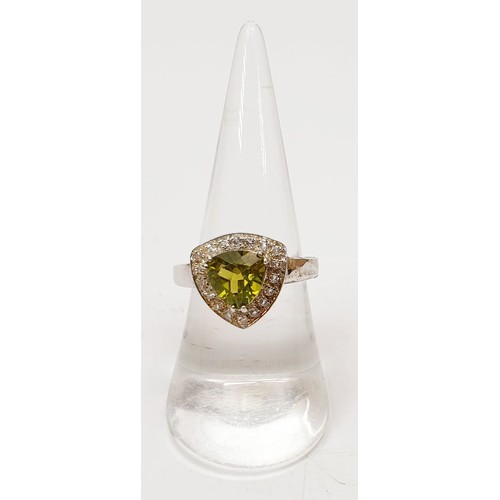 31 - A 925 silver ring set with peridot and white topaz, size N/O. UK shipping £14.