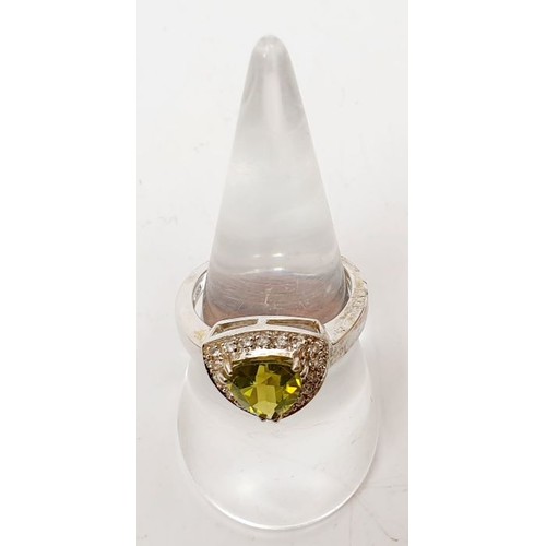 31 - A 925 silver ring set with peridot and white topaz, size N/O. UK shipping £14.