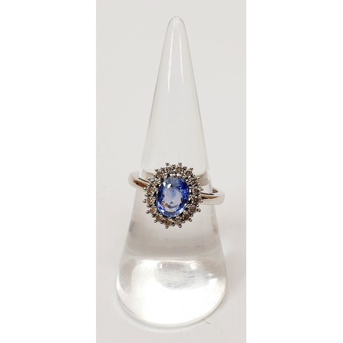 19 - A hallmarked 9ct white gold Ceylon sapphire and diamond cluster ring, size O, gross weight 2.7g. UK ... 