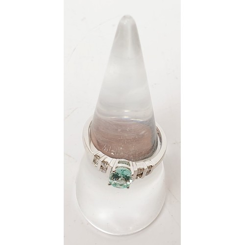 21 - A hallmarked 18ct white gold ring set with Mozambique tourmaline and diamond, size O/P, gross weight... 