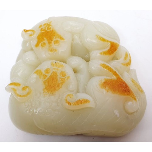 75 - A Chinese rustic jade carving modelled as two cats with a ball, width 3