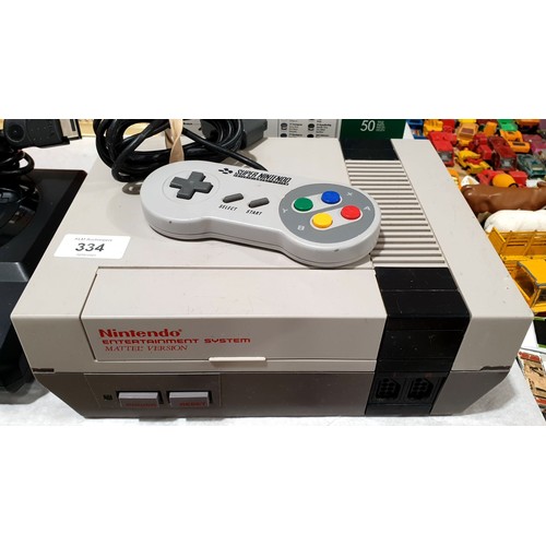 334 - A Nintendo NES Mattel version A/F, together with a SNES controller. Electricals are sold as scrap. U... 