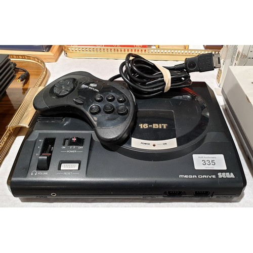 335 - A Sega Megadrive together with a Sega Saturn controller. Electricals are sold as scrap. UK shipping ... 