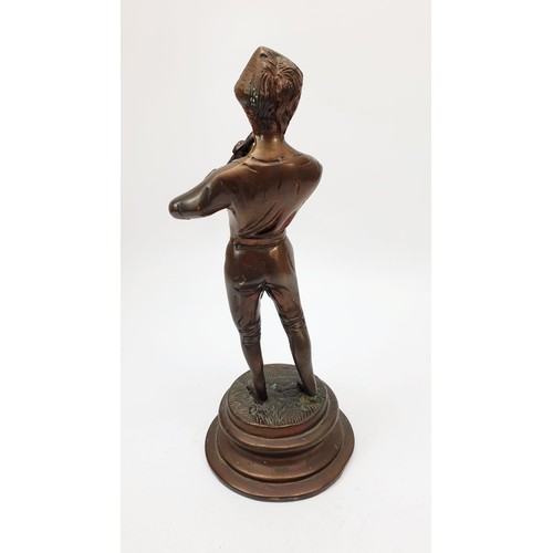 348 - A vintage bronzed spelter figure of a boy with a penny whistle, height 9.5