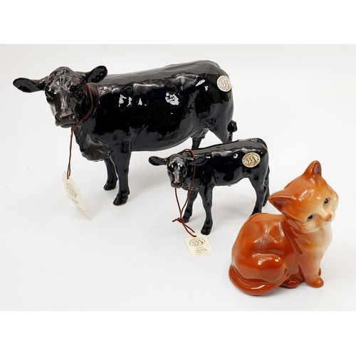 355 - A Border Fine Arts Pottery Company model of an Aberdeen Angus cow and calf, the widest, 6.5