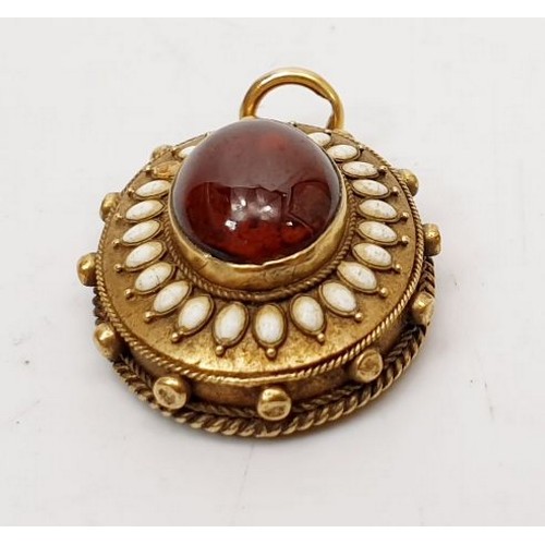 11 - An antique yellow metal pendant, testing to a high carat set with a red and white stones and photo a... 