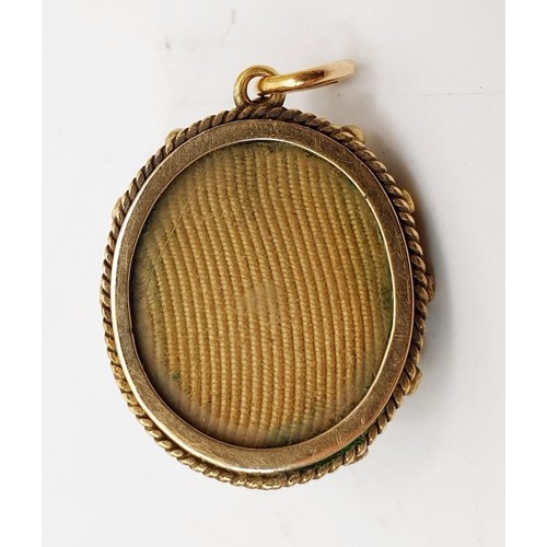 11 - An antique yellow metal pendant, testing to a high carat set with a red and white stones and photo a... 