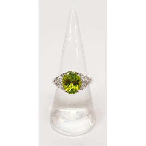 23 - A hallmarked 9ct white gold ring set with peridot and diamond, size O/P, gross weight 3.3g. UK shipp... 