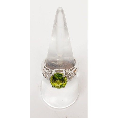 23 - A hallmarked 9ct white gold ring set with peridot and diamond, size O/P, gross weight 3.3g. UK shipp... 