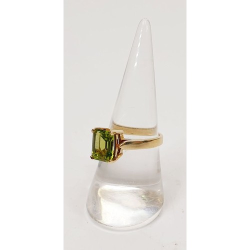 27 - A hallmarked 9ct gold ring set with peridot, size N/O, gross weight 3.7g. UK shipping £14.