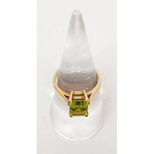 27 - A hallmarked 9ct gold ring set with peridot, size N/O, gross weight 3.7g. UK shipping £14.