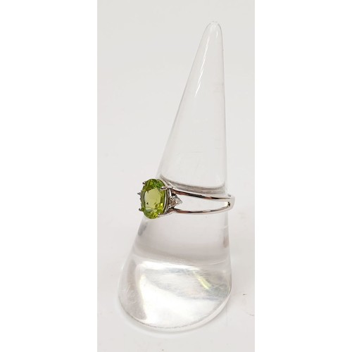 34 - A hallmarked 9ct white gold ring set with peridot and diamond, size O, gross weight 1.8g. UK shippin... 