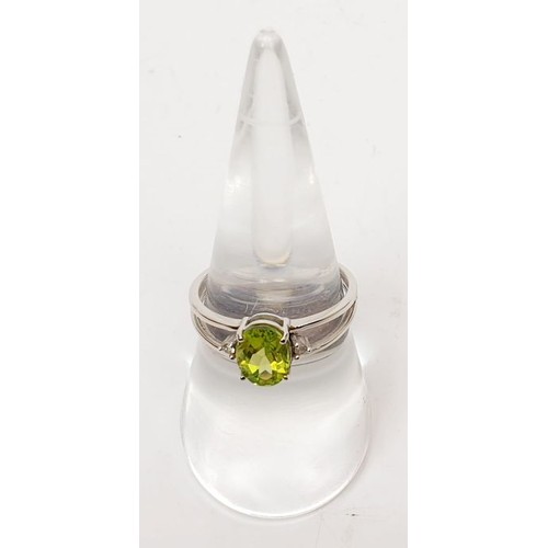 34 - A hallmarked 9ct white gold ring set with peridot and diamond, size O, gross weight 1.8g. UK shippin... 