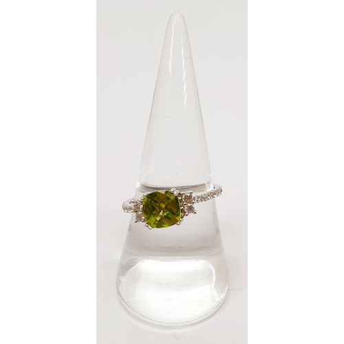 63 - A platinum plated silver ring set with peridot and zircon, size Q. UK shipping £14.