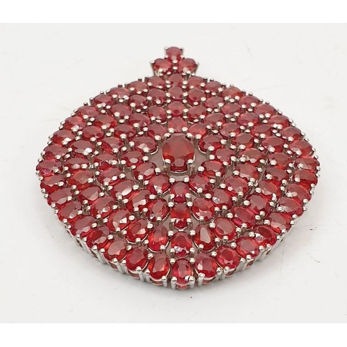 80 - A large hallmarked silver pendant set with 100 rubies, length 2