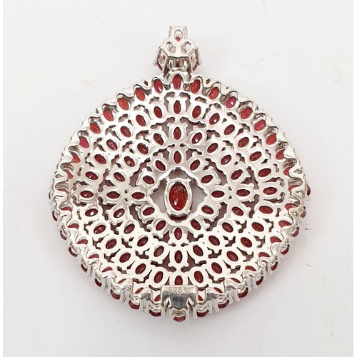 80 - A large hallmarked silver pendant set with 100 rubies, length 2