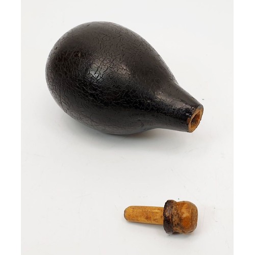 99 - An antique wooden lacquered pear shaped bottle, length 3.5