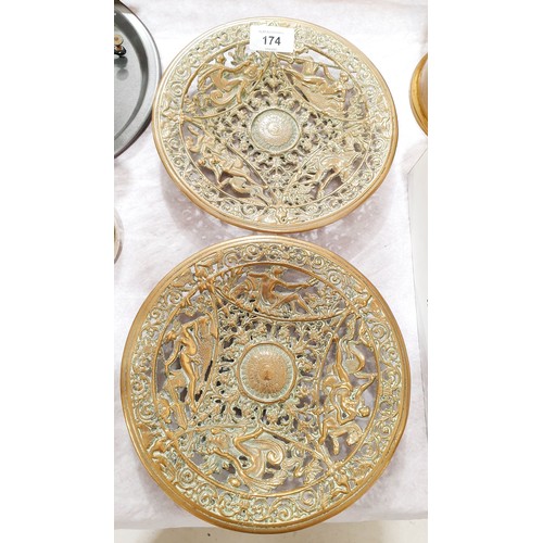 174 - A pair of antique brass roundels with pierce work decoration depicting Neptune, nymphs and sea monst... 