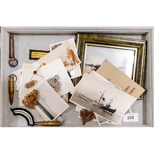 235 - A selection of vintage photographs including military shipping together with military insignia and a... 