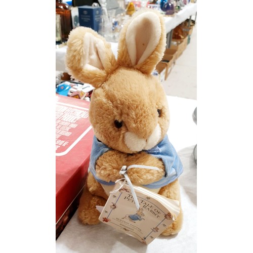 301 - A Beatrix Potter Peter Rabbit soft toy and a book, length 11