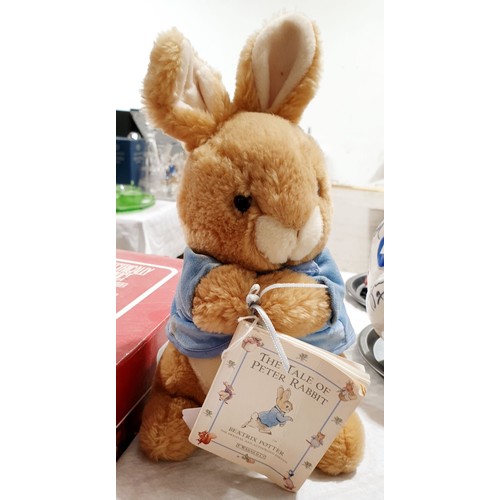 301 - A Beatrix Potter Peter Rabbit soft toy and a book, length 11