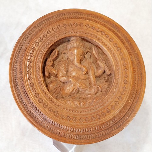 404 - A vintage intricately carved wooden box, the lid portraying Ganesh and the sides carved with foliage... 