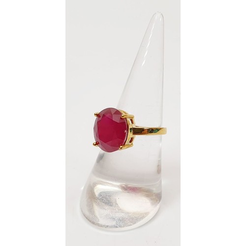 15 - A hallmarked 9ct gold ring set with a treated ruby, size N/O, gross weight 3.9g. UK shipping £14.