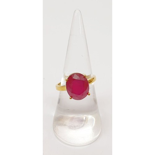 15 - A hallmarked 9ct gold ring set with a treated ruby, size N/O, gross weight 3.9g. UK shipping £14.