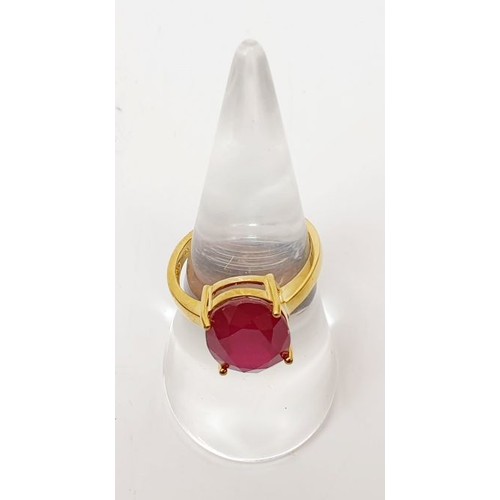 15 - A hallmarked 9ct gold ring set with a treated ruby, size N/O, gross weight 3.9g. UK shipping £14.