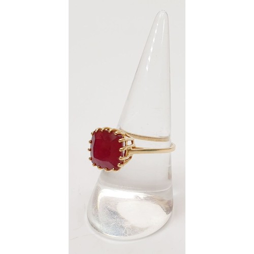 21 - A hallmarked 9ct gold ring set with treated ruby, size Q, gross weight 3.2g. UK shipping £14.