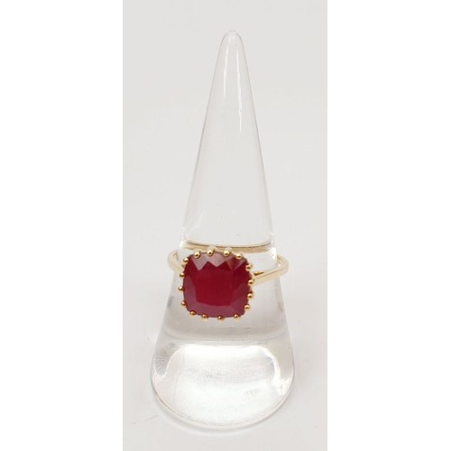 21 - A hallmarked 9ct gold ring set with treated ruby, size Q, gross weight 3.2g. UK shipping £14.