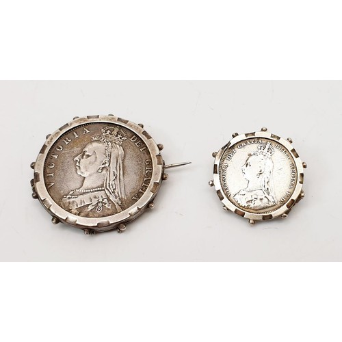 56 - Two Victorian silver coins held in white metal brooch mounts, gross weight 26g. UK shipping £14.