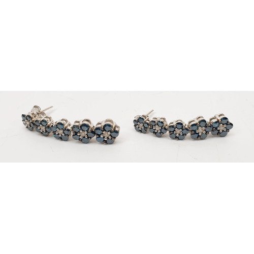 36 - A pair of hallmarked 9ct white gold earrings set with blue and white diamond. UK shipping £14.