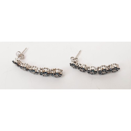 36 - A pair of hallmarked 9ct white gold earrings set with blue and white diamond. UK shipping £14.