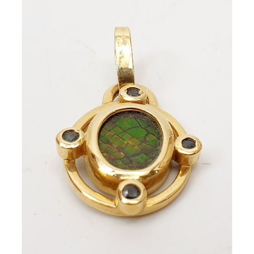 43 - A hallmarked 14ct gold pendant set with ammonite, gross weight 2.7g. UK shipping £14.