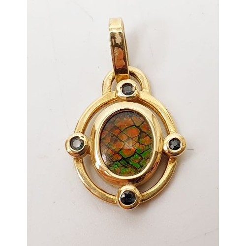 43 - A hallmarked 14ct gold pendant set with ammonite, gross weight 2.7g. UK shipping £14.