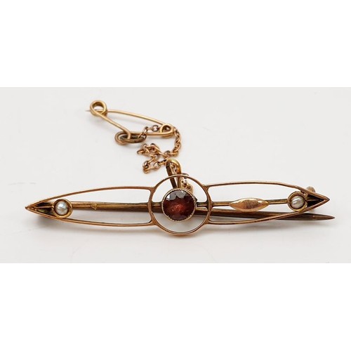 45 - An antique yellow metal bar brooch set with a red stone and seed pearls A/F, gross weight 2.4g. UK s... 