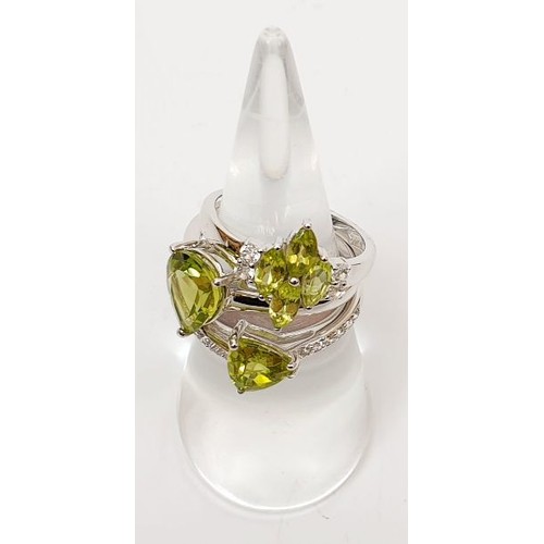 46 - A set of three stacking silver and peridot set rings, size N/O. UK shipping £14.