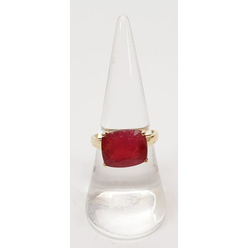 28 - A hallmarked 9ct gold ring set with a treated ruby, size O, gross weight 3.5g. UK shipping £14.