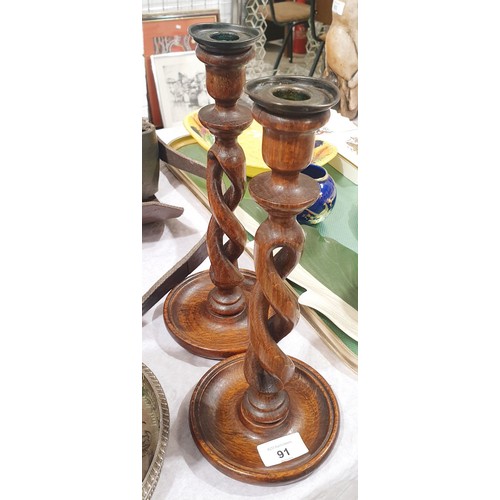 91 - A pair of vintage oak open twist candlesticks, height 11.75