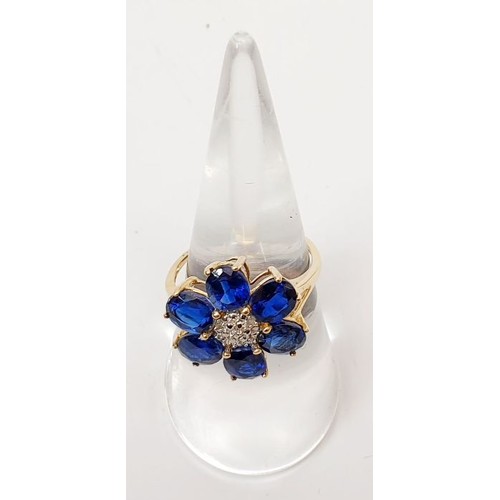 11 - A hallmarked 9ct gold ring set with blue and white stones, size O, gross weight 3g. UK shipping £14.