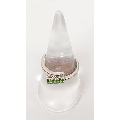 23 - A hallmarked 9ct white gold ring set with tsavorite, size N, gross weight  2.9g. UK shipping £14.