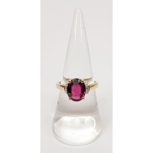 27 - A hallmarked 9ct gold ring set with rubellite and diamond, size N/O, gross weight 2.9g. UK shipping ... 