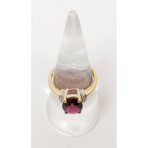 27 - A hallmarked 9ct gold ring set with rubellite and diamond, size N/O, gross weight 2.9g. UK shipping ... 