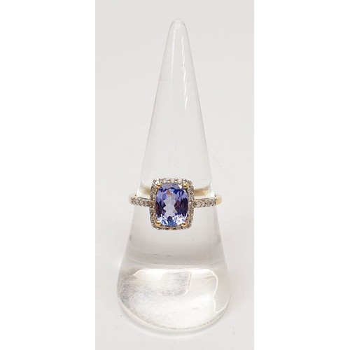 28 - A hallmarked 18ct gold tanzanite and diamond cluster ring, size N/O, gross weight 2.5g. UK shipping ... 