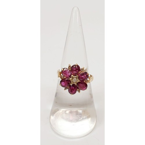 38 - A hallmarked 9ct gold ruby and diamond cluster ring, size M, gross weight 3.2g. UK shipping £14.