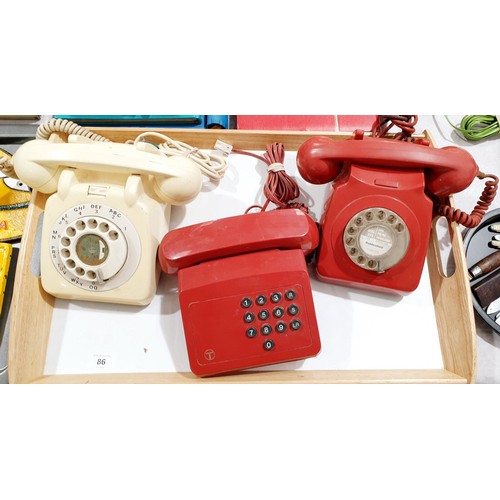 86 - A 1960s red GPO telephone, one other 1960s telephone and a later telephone. UK shipping £14.